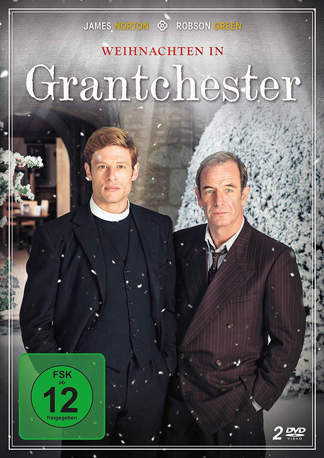 Zwei Männer in Anzügen, einer mit Brille, auf DVD-Cover, fallender Schnee.