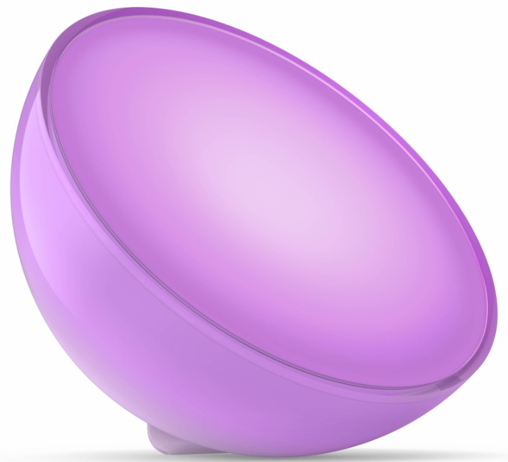 Una lampada viola arrotondata con un coperchio trasparente è su una superficie bianca. La lampada è inclinata, mostrando la sua forma.