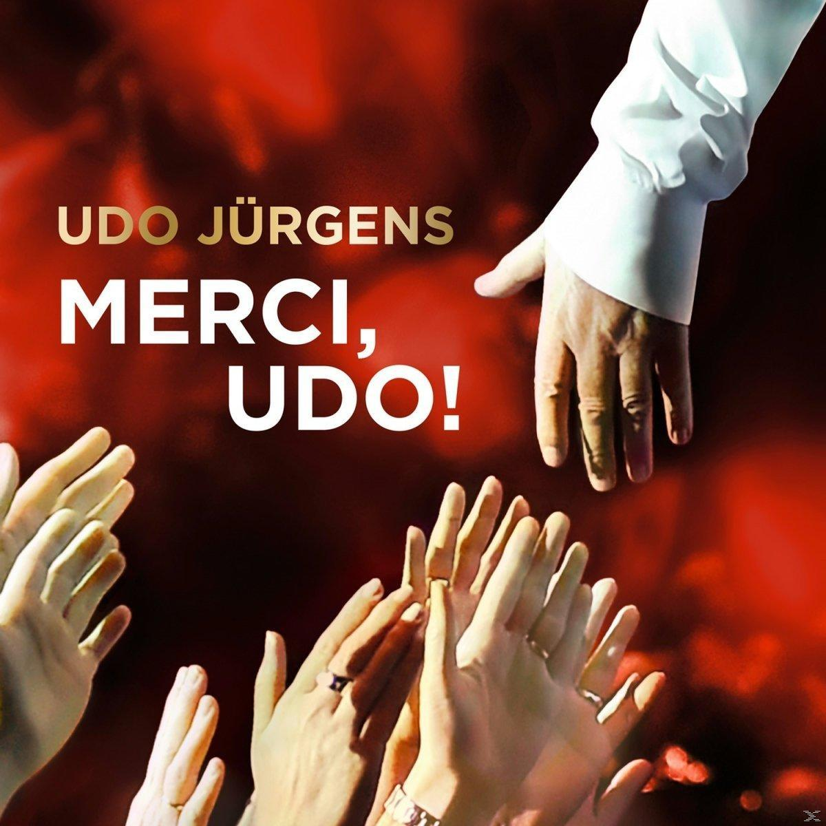 Das Bild zeigt 'Udo Jürgens Merci, Udo!'. Hände greifen danach, roter Hintergrund.