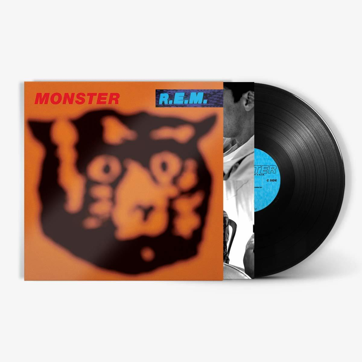 Albumcover für 'Monster' von R.E.M. mit orangefarbenem Hintergrund und verschwommenem Katzenbild. Vinyl sichtbar.