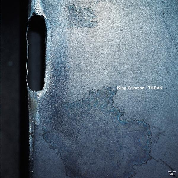 Album borító fém felülettel, textúrákkal és a 'King Crimson THRAK' szöveggel.