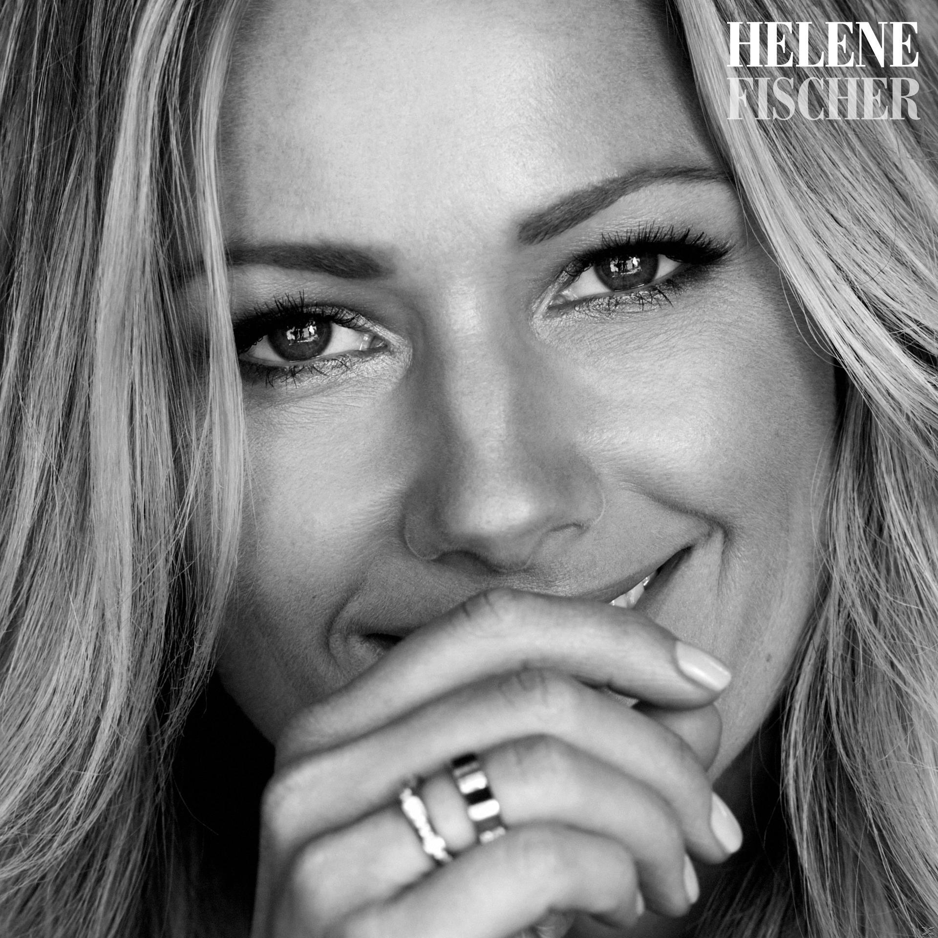 Gros plan d'une femme blonde souriante, mains sur la bouche, portant des bagues.