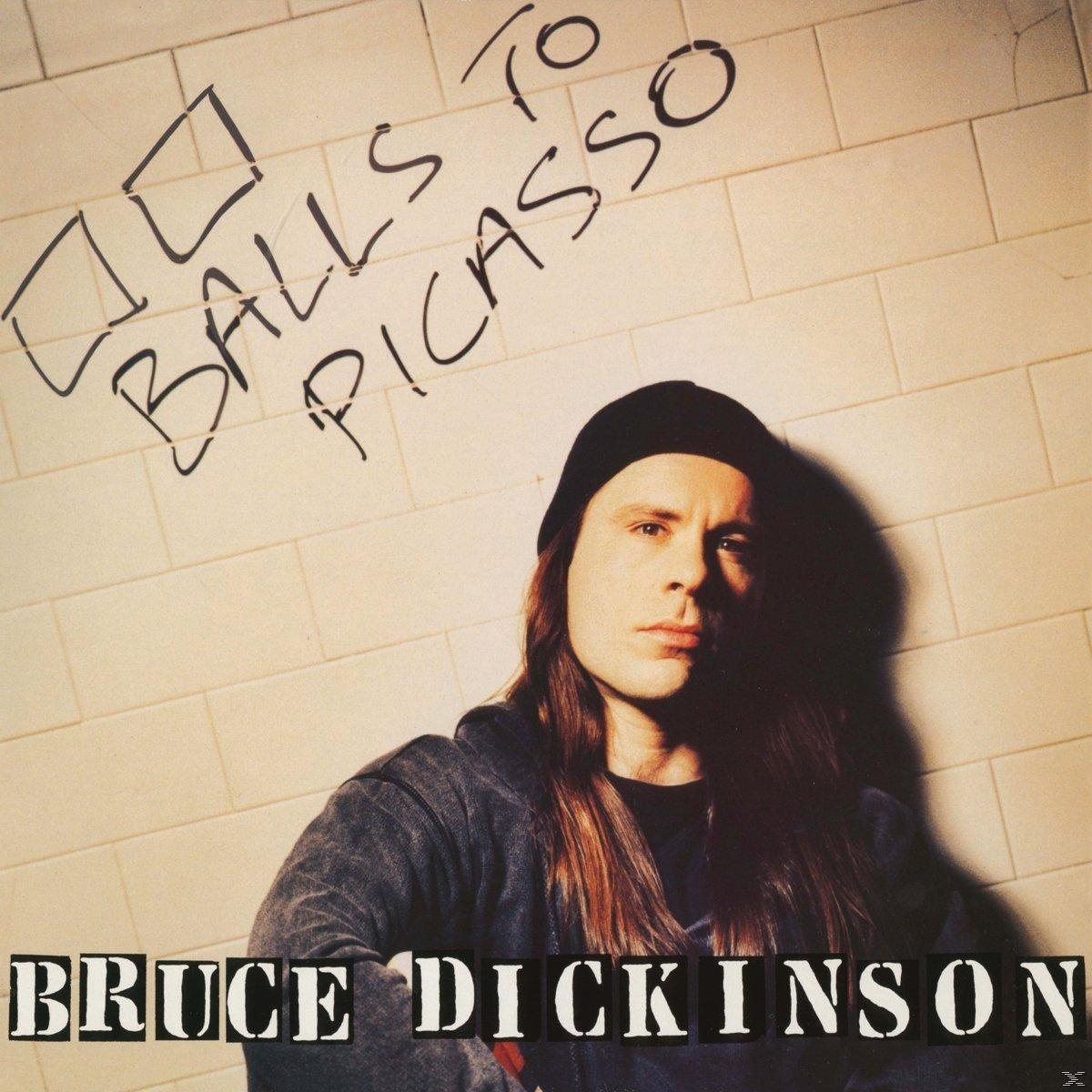 Bruce Dickinson album borító. Szöveg: "Balls to Picasso". Hosszú hajú férfi, fekete sapka, téglás háttérrel.