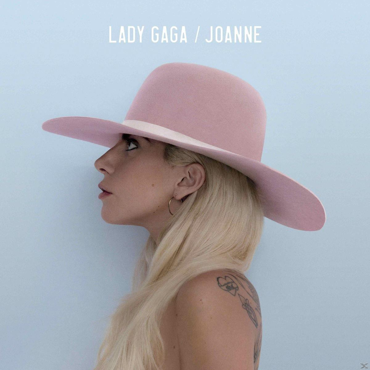 Lady Gaga album borító. Gaga rózsaszín kalapban, szőke hajjal és tetoválással.
