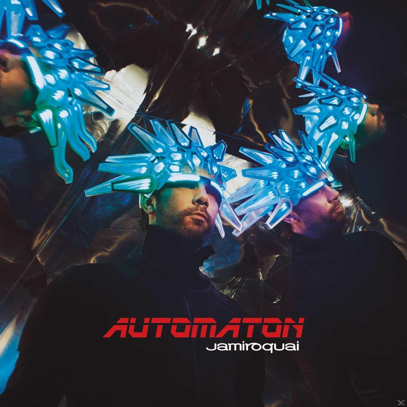 Jamiroquai Automaton album borító egy férfival fekete garbóban, neon fejfedővel.