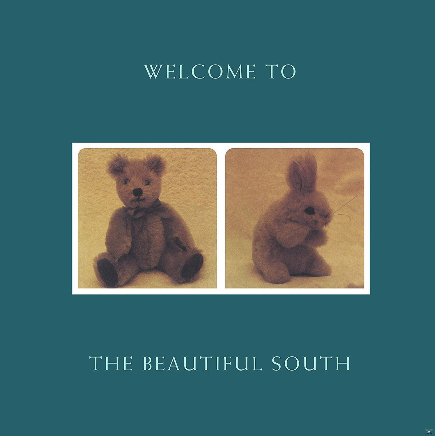 Album borító kék háttérrel, "WELCOME TO THE BEAUTIFUL SOUTH" szöveggel és két plüssállat fotóval.