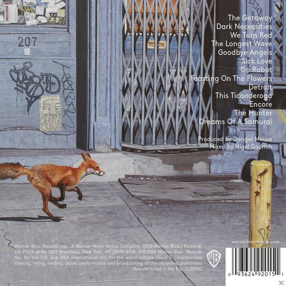 Urbaner Szene mit einem Fuchs, der rennt. Im Hintergrund ein Gebäude mit Graffiti und die Trackliste des Albums.