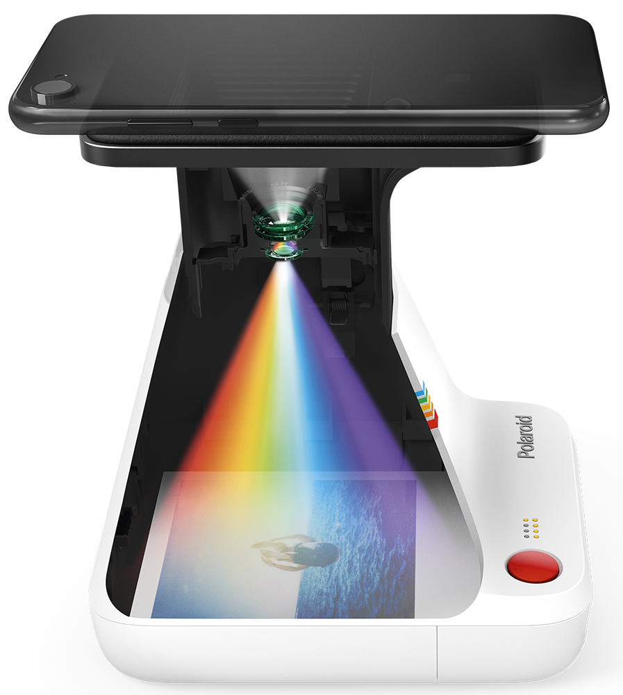 Polaroid lab projecting a rainbow onto a photo with a phone on top.