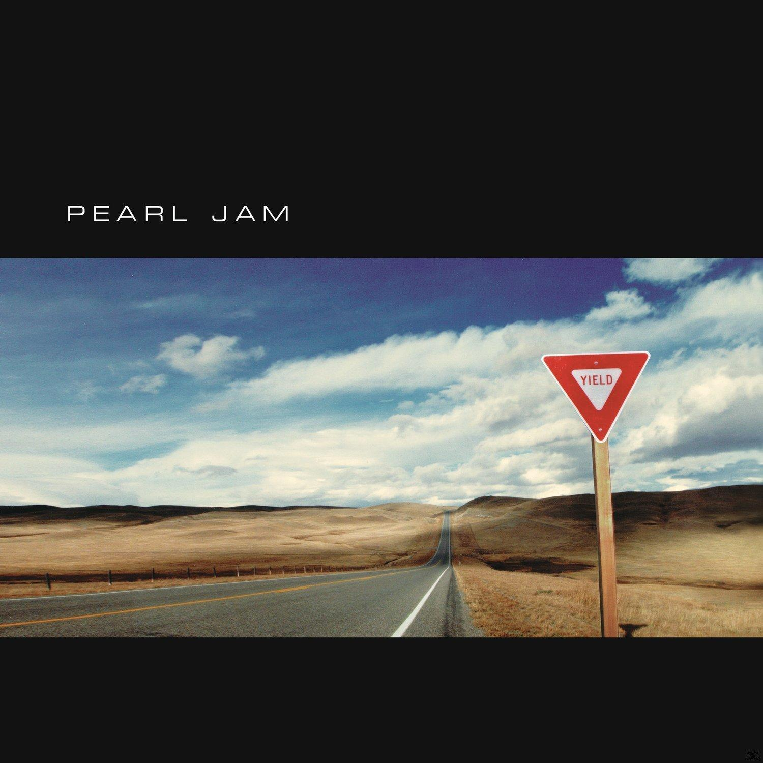 Pearl Jam album borítója. Út a felhős kék ég alatt a megállj táblához.