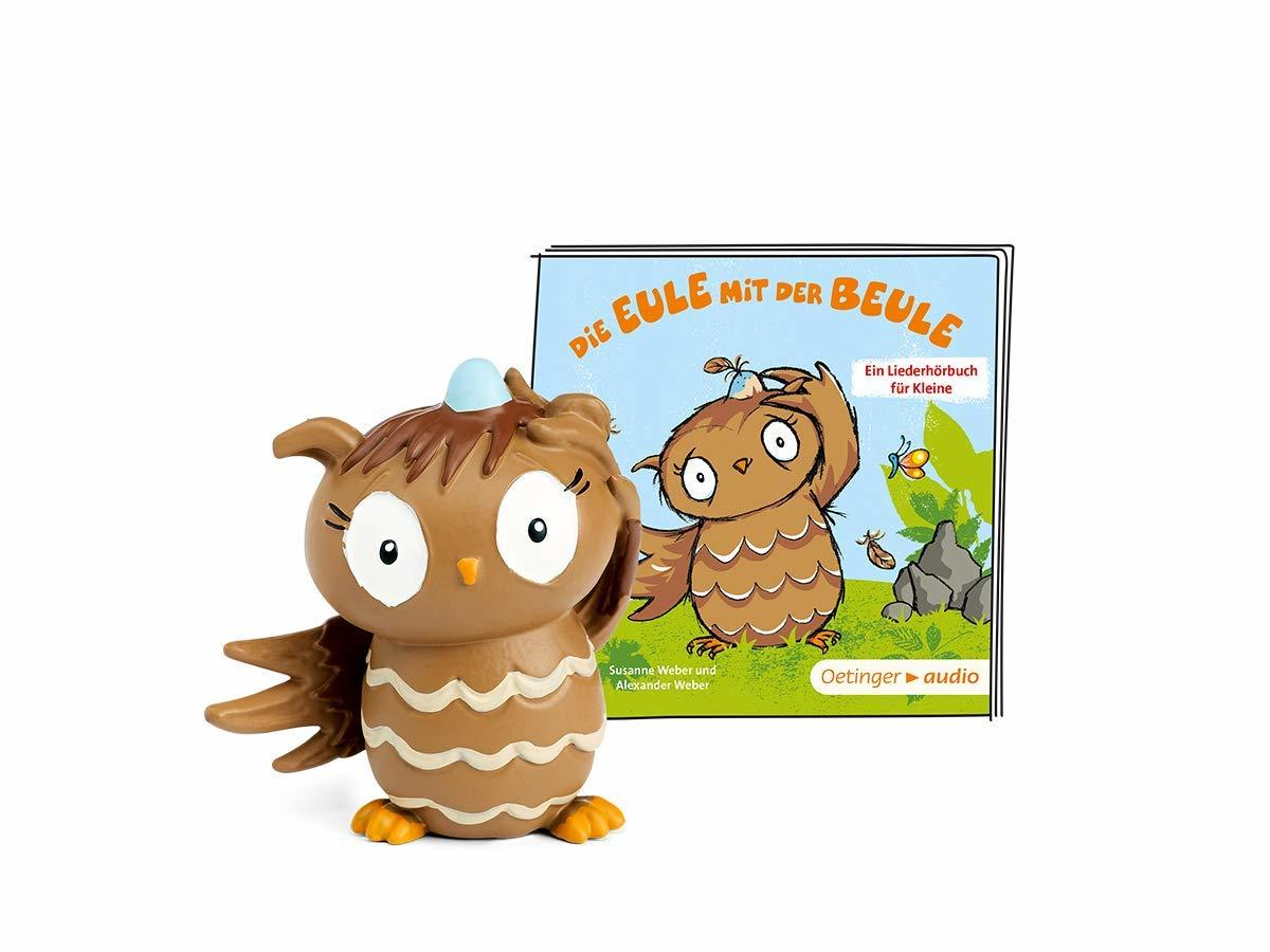 Eine Eulenfigur und ein Buch mit dem Titel Die Eule mit der Beule. Das Buchcover zeigt einen Eulen-Cartoon.