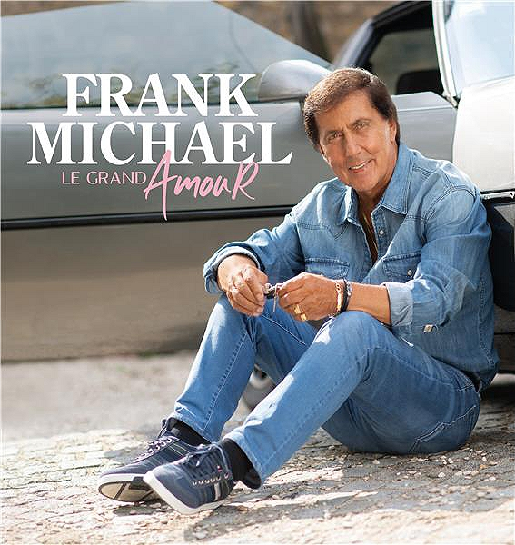 Frank Michael albumhoes. Een man in een spijkerbroek zit naast een zilveren auto.