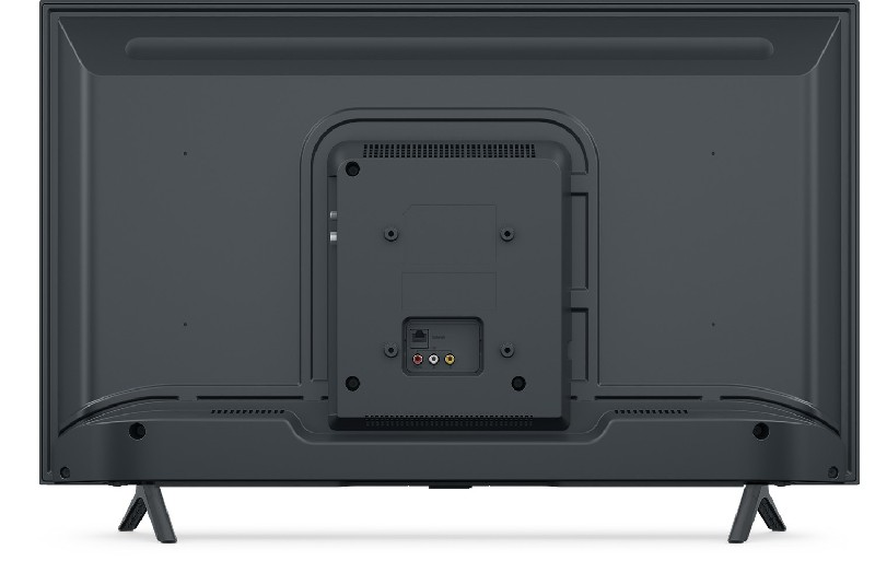 Parte trasera de un televisor gris oscuro con varios puertos y un soporte sobre un fondo blanco.