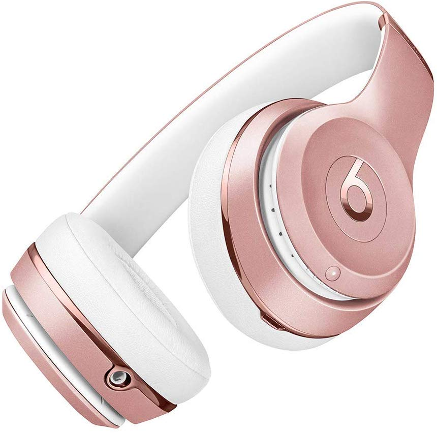 Auriculares oro rosa con orejeras blancas y diadema blanca.