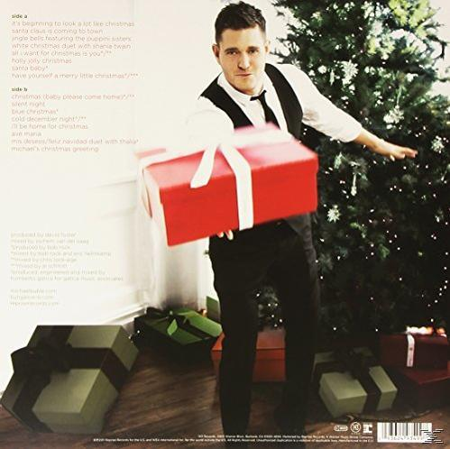 Michael Bublé Albumcover, Bublé hält ein rotes Geschenk vor einem Weihnachtsbaum.