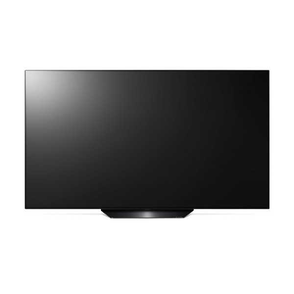 Televisor de pantalla plana negro grande con soporte. La pantalla está apagada y se ve reflejo.