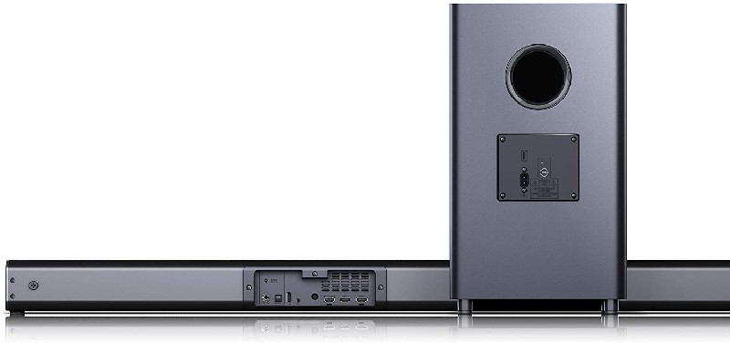 Barra de sonido y subwoofer sobre fondo blanco, gris oscuro.