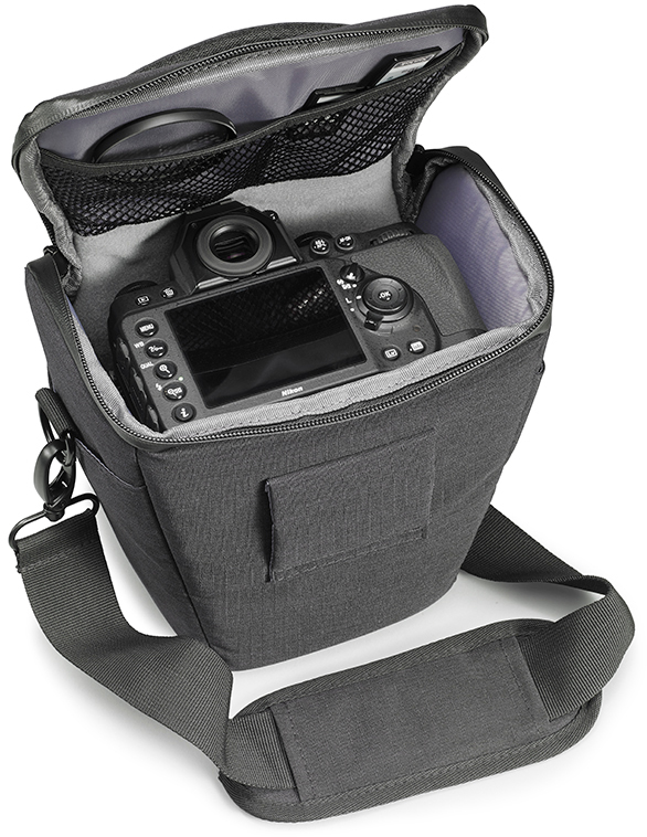 An open camera bag with a Nikon DSLR inside. The bag is dark gray, with a shoulder strap and mesh pockets.