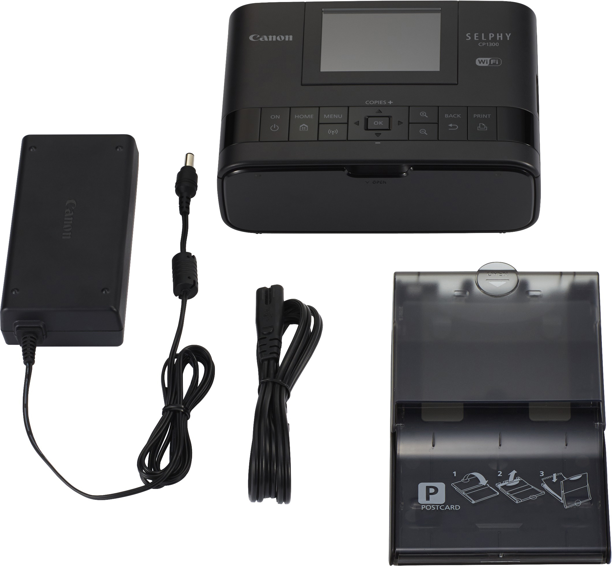 Imprimante Canon Selphy, adaptateur secteur et bac à papier. Tout noir, sur fond blanc.