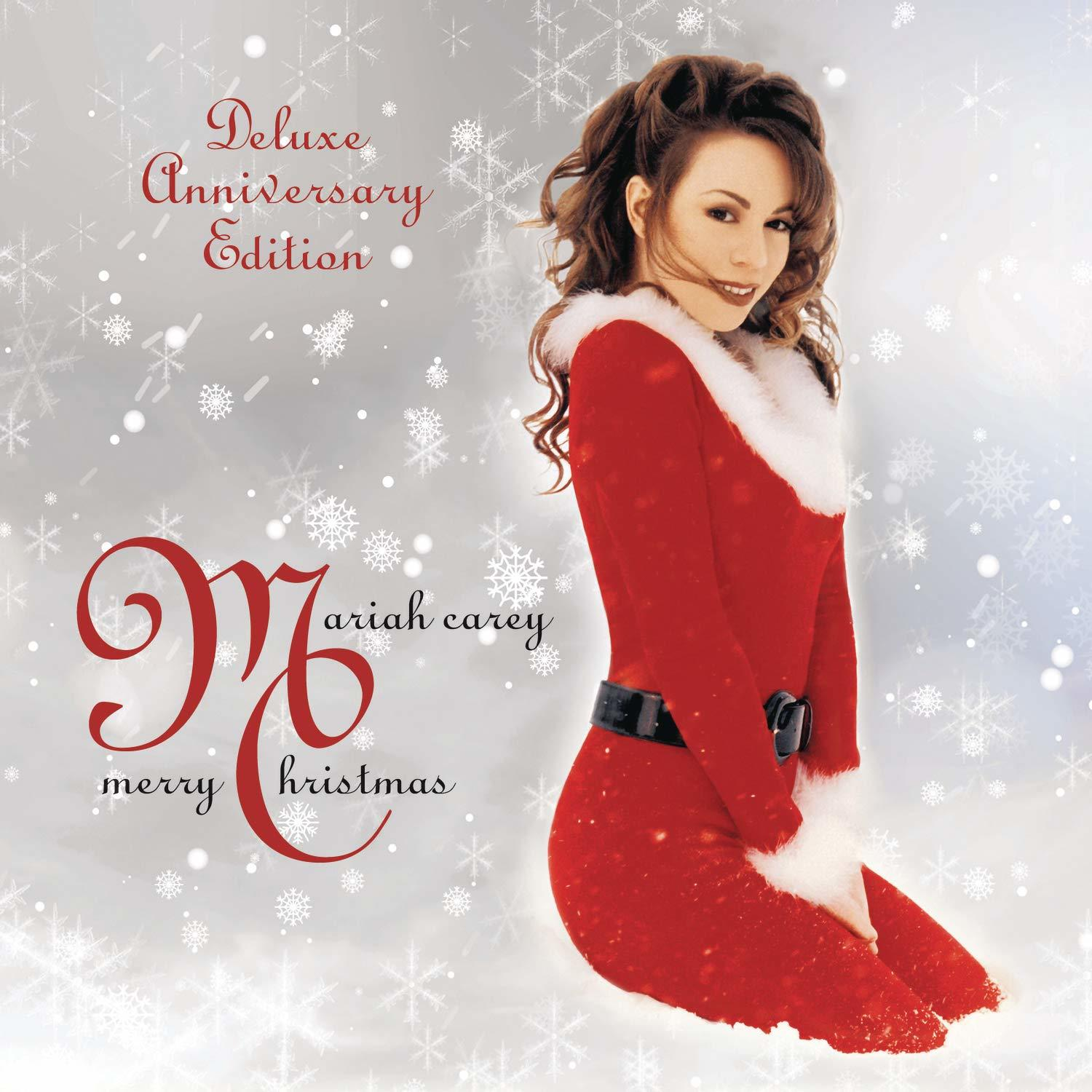 Mariah Carey, piros ruha, karácsonyi album borítója hópelyhekkel és szöveggel.