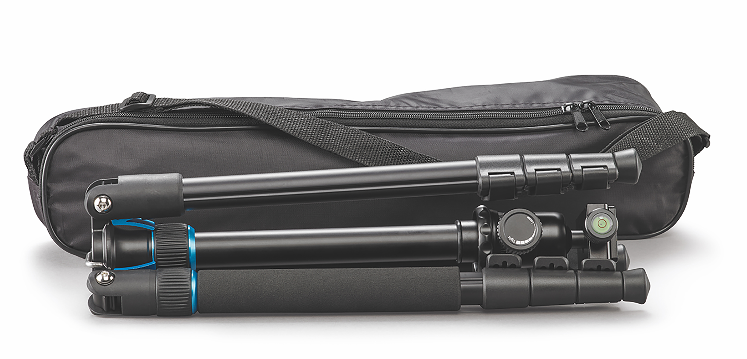 Tripod and carrying case, black, lying on a white surface.