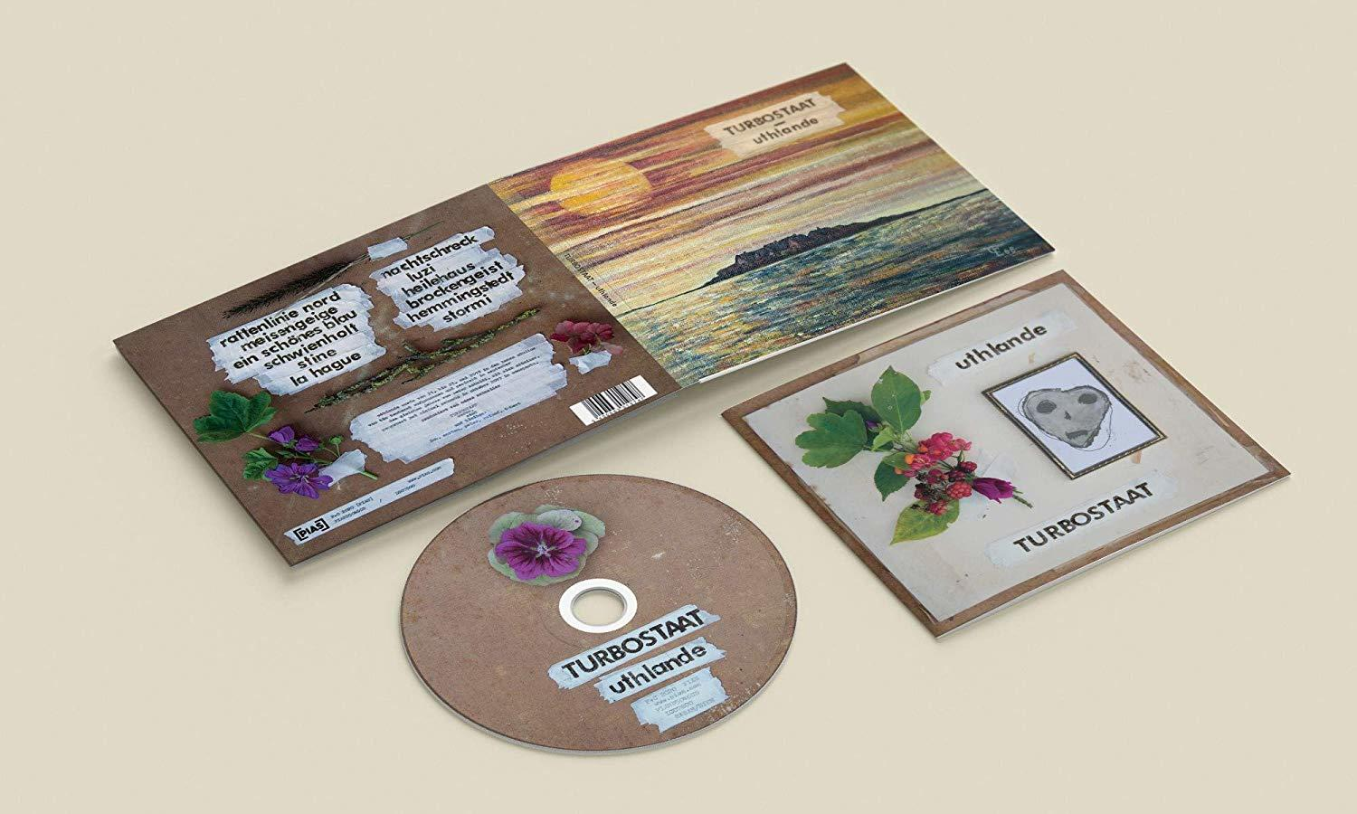 CD-Hülle, offen, mit CD und Artwork auf beiger Oberfläche.