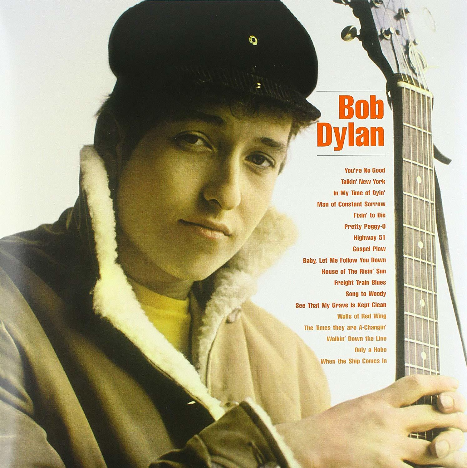 Bob Dylan gitárral, sapkában és kabátban. Album borító a jobb oldalon a dalcímekkel.
