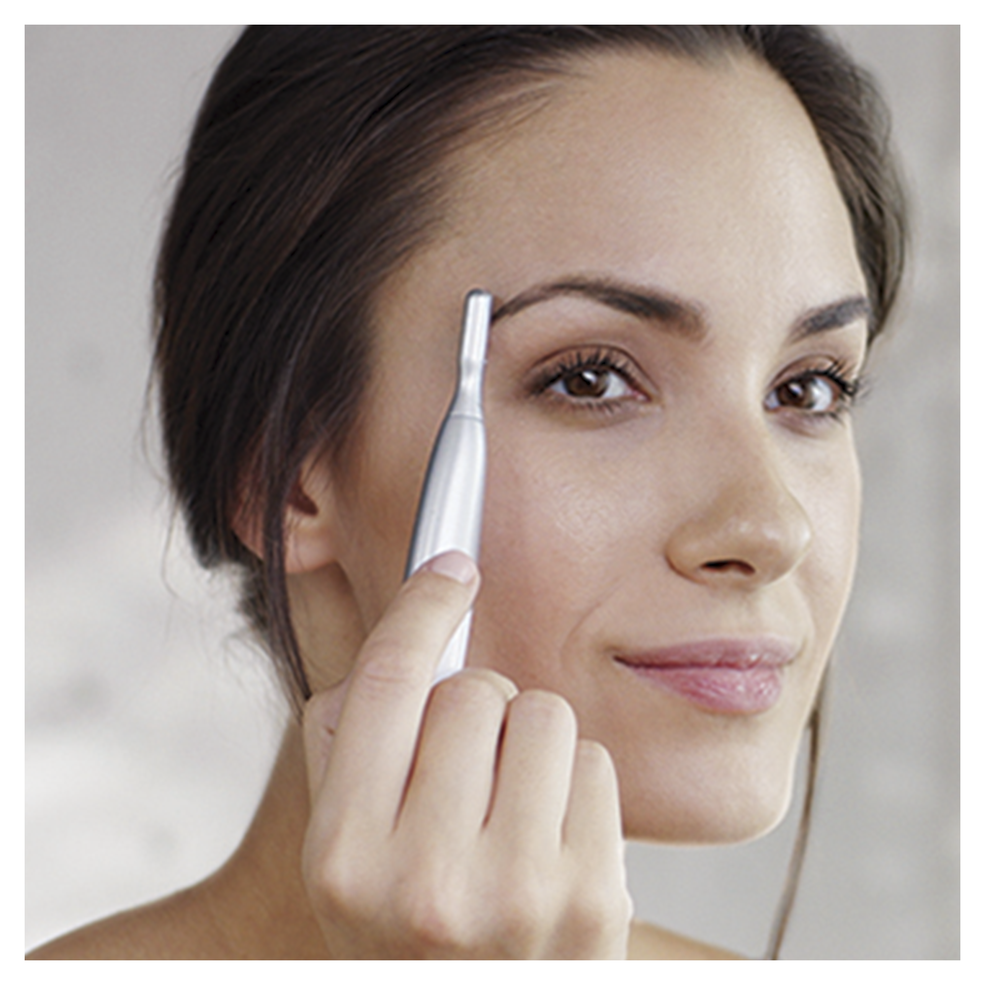 A woman using an eyebrow trimmer, close-up shot, looking at the camera.