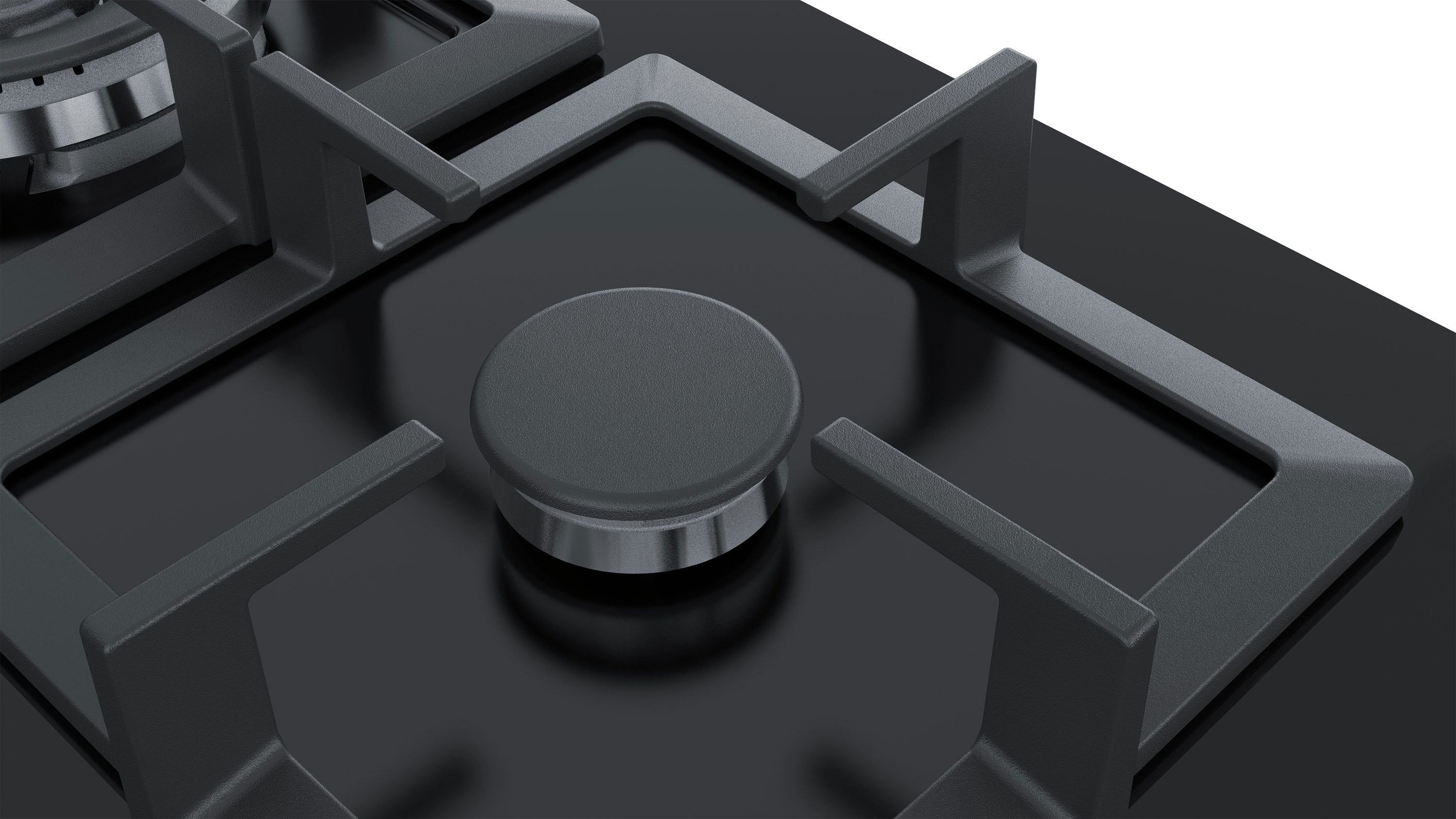 Black gas stove with burners and grates. Dark gray color. Close-up view.