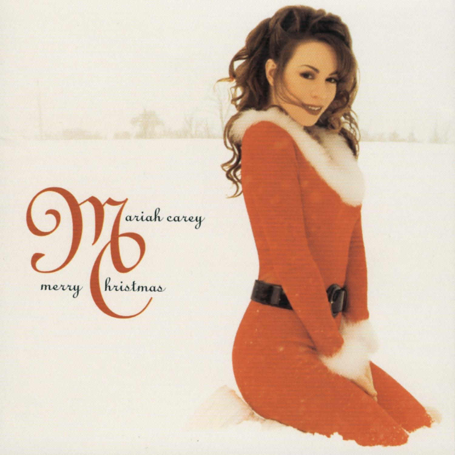 Mariah Carey vor schneebedecktem Hintergrund, trägt rotes Kleid mit weißem Fell. Text 'Merry Christmas'.