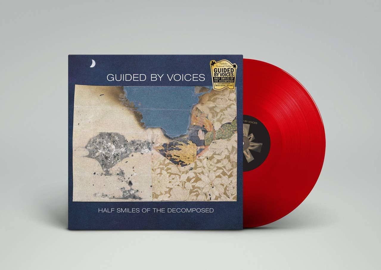 Albumcover mit dunkelblauem Hintergrund und rotem Vinyl. Das Album trägt den Titel 'Half Smiles of the Decomposed'.
