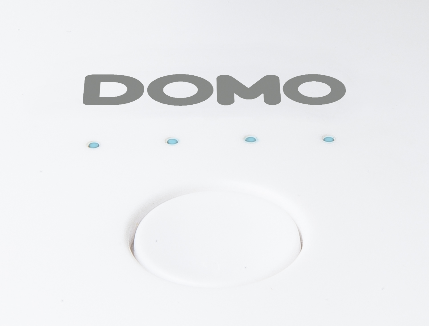 White surface with DOMO text and four blue lights. White background.