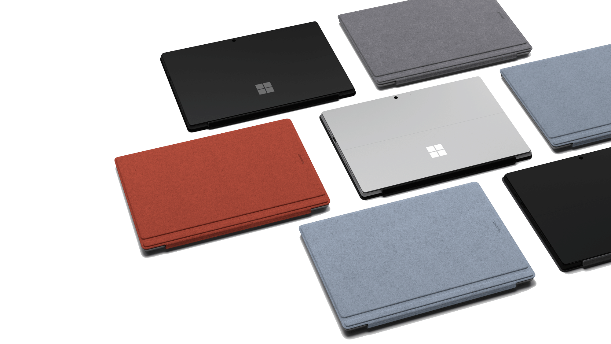 Laptops. Meerdere laptops met verschillende kleuren covers, gerangschikt in een patroon. Zwarte achtergrond.