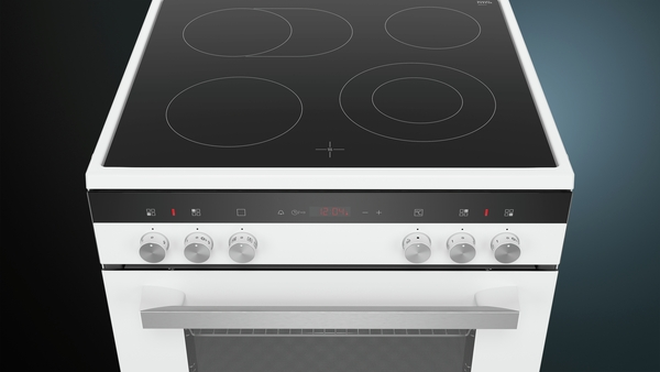 A white stovetop with four black burners and a control panel at the front.