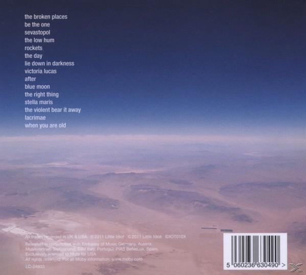 CD-Cover mit einer Liste von Titeln auf dem Hintergrund einer Landschaft mit blauem Himmel.