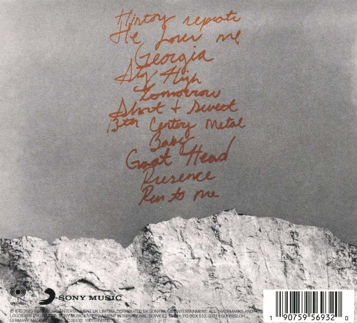 Dos d'une pochette de CD avec des titres de chansons manuscrits sur fond orange.