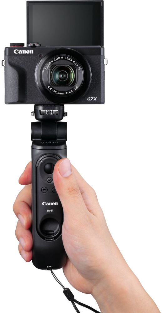 Een hand die een Canon camera vasthoudt die is bevestigd aan een zwarte Canon BR-E1 afstandsbediening/statief.