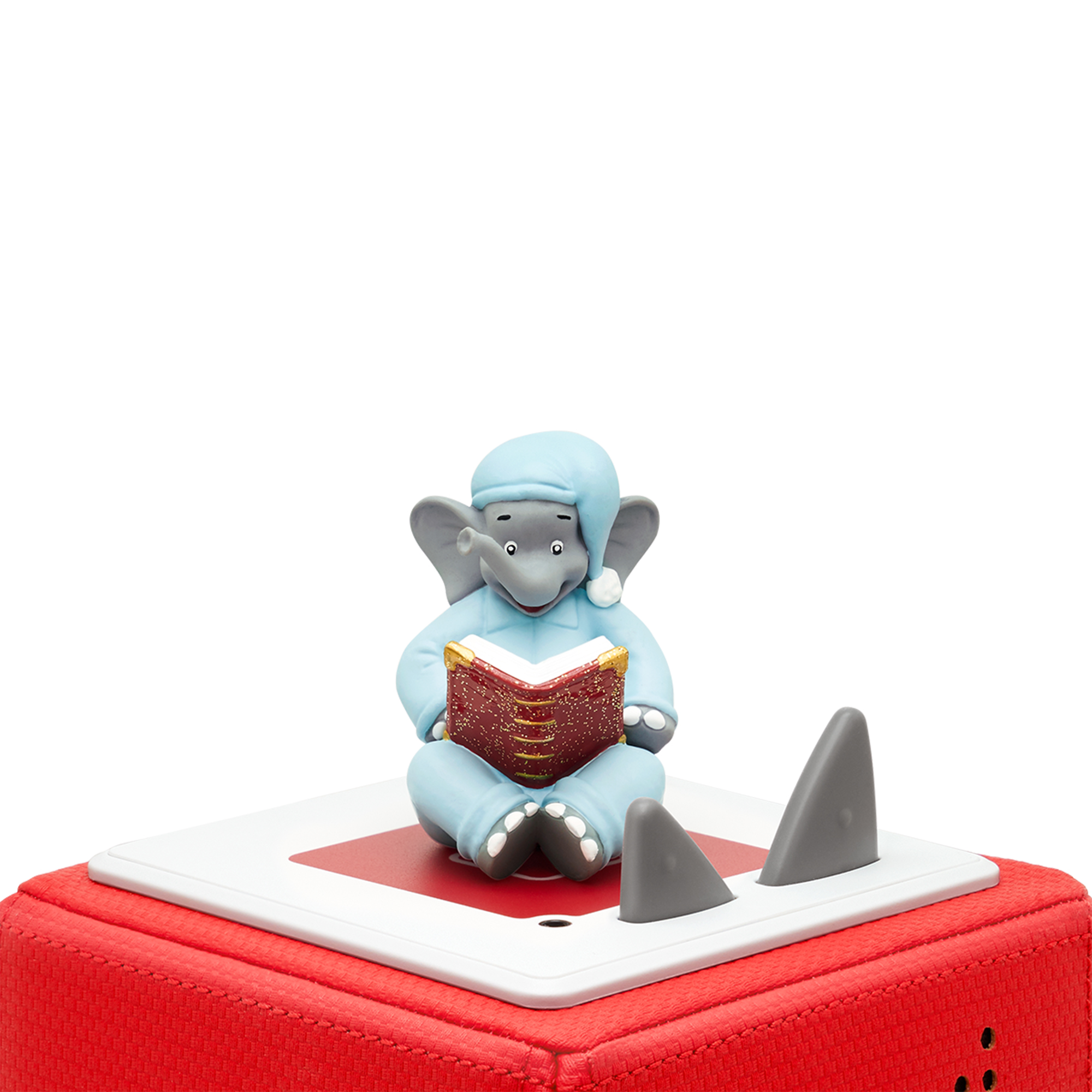 Ein Elefant im blauen Schlafanzug liest ein rotes Buch auf roter Basis.