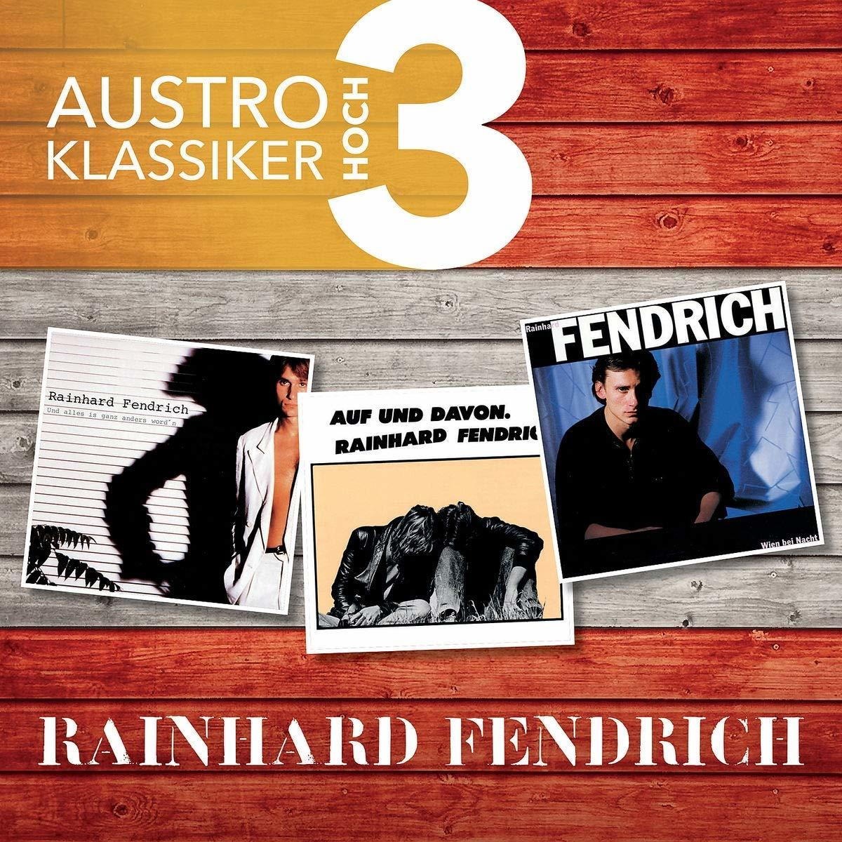 Albumcover mit drei Reinhard Fendrich Albumcovern auf Holzuntergrund.