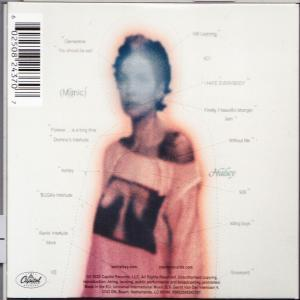 Albumcover mit einem verschwommenen Bild einer Person. Text und ein Barcode sind sichtbar. Das Bild ist meist orange und weiß.