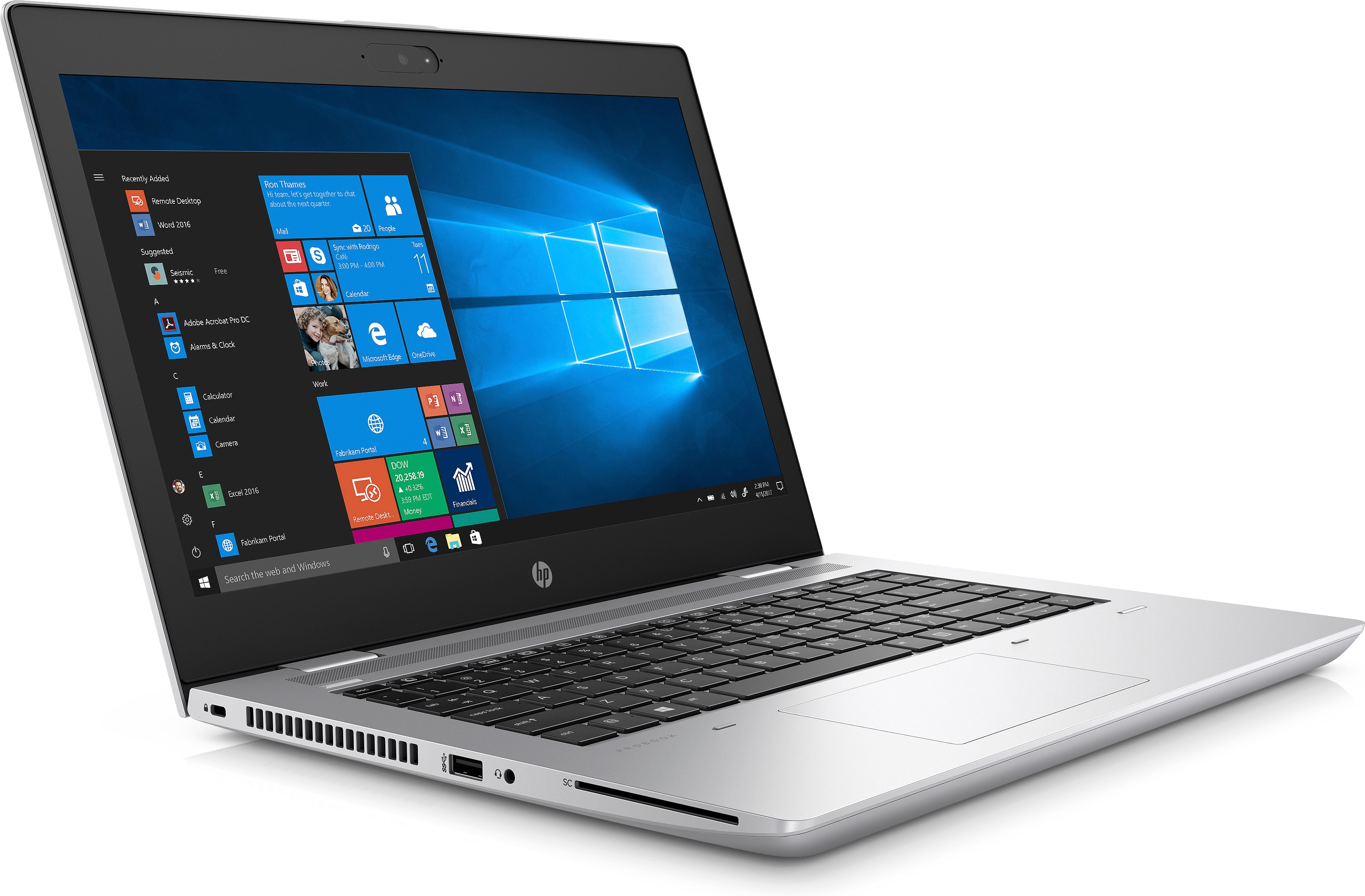 Laptop mit Windows-Oberfläche auf dem Bildschirm, silbernes Gehäuse, auf weißer Oberfläche.