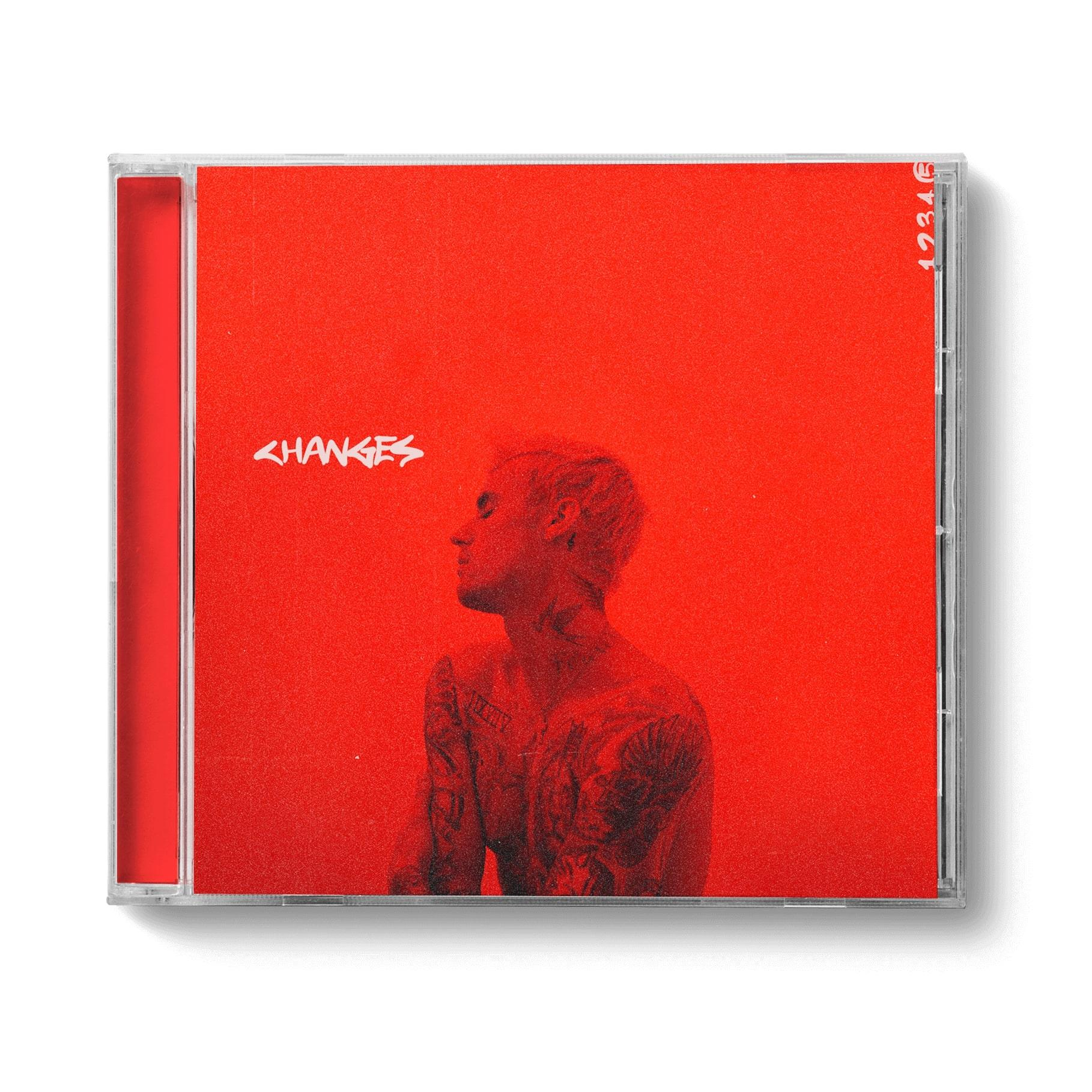 Albumhoes voor "Changes" van Justin Bieber, rode achtergrond, afbeelding van de zanger, witte tekst.