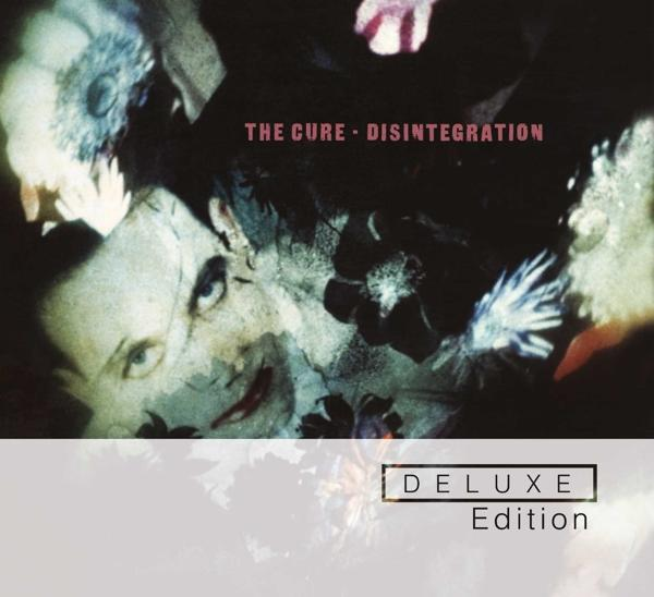 Albumcover, dunkel mit Gesicht und Blumen, der Text 'THE CURE - DISINTEGRATION - DELUXE Edition'.