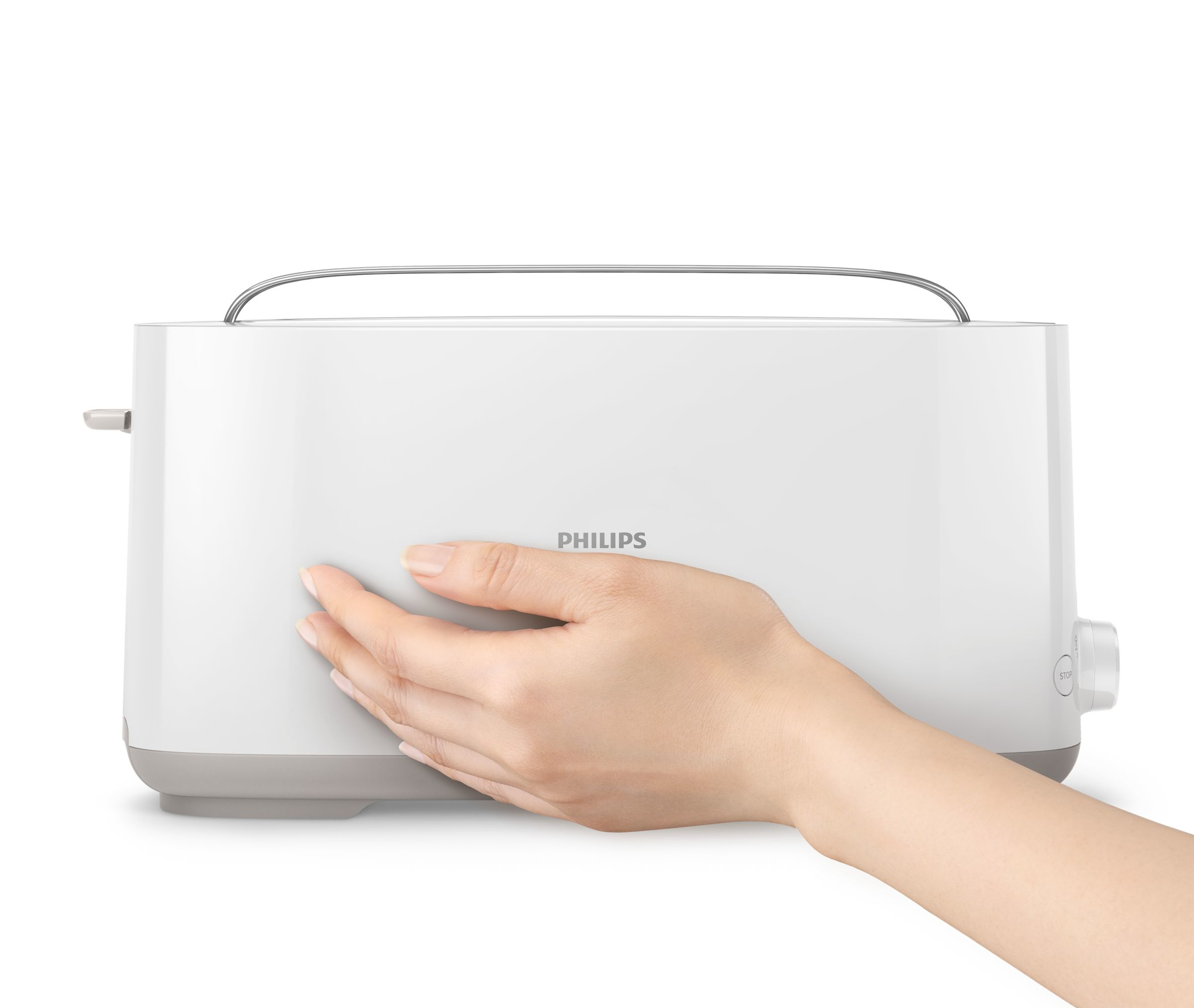 A hand touching a white Philips toaster on a white surface. The Philips logo is visible.