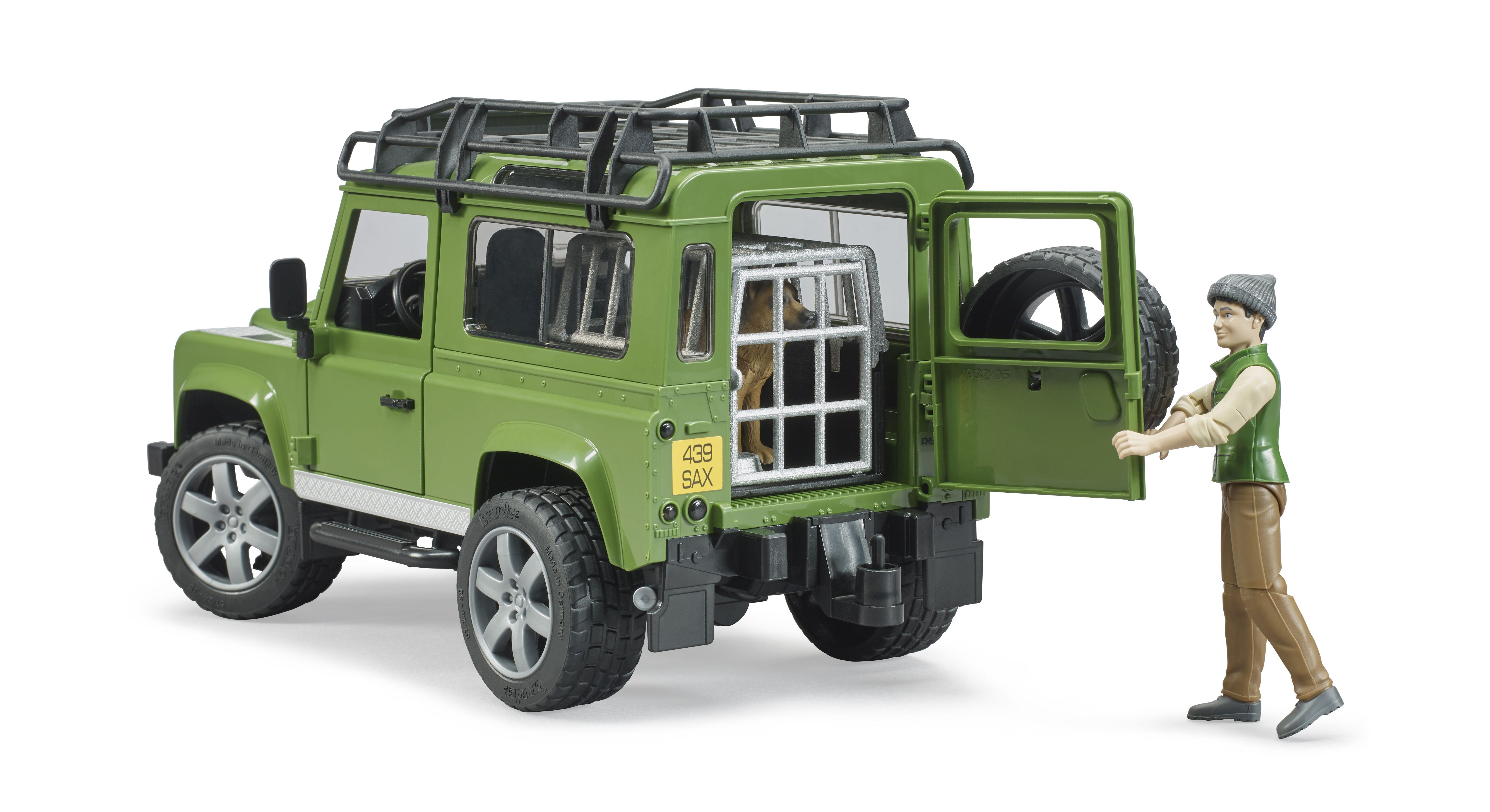 Ein grüner Spielzeug-SUV mit einem Hund in einem Käfig und einem Mann, der die Tür öffnet.
