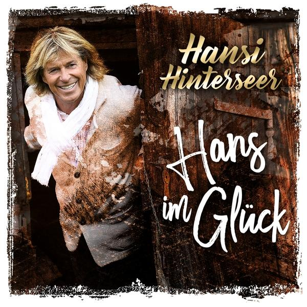 Albumcover für Hansi Hinterseer. Es zeigt einen Mann, der in einer Tür lächelt, mit Text.