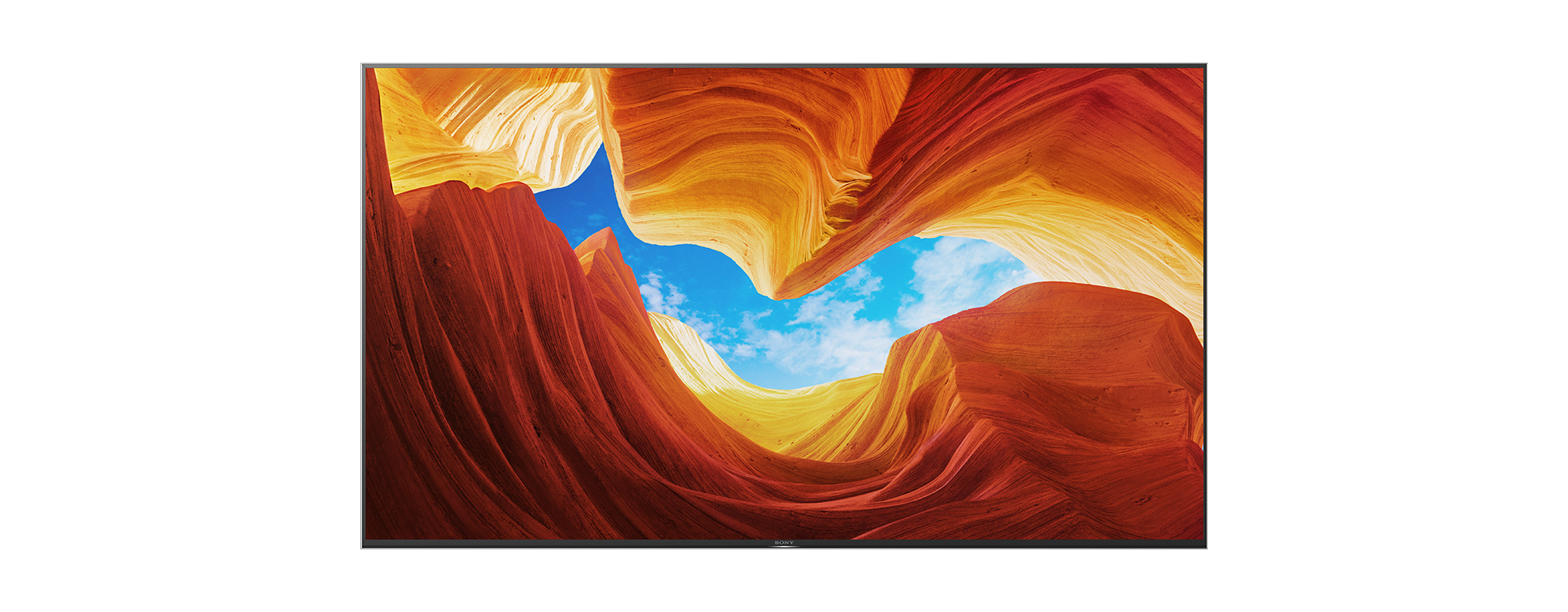 TV-Bildschirm mit einer orange-gelben Felsformation unter blauem Himmel.