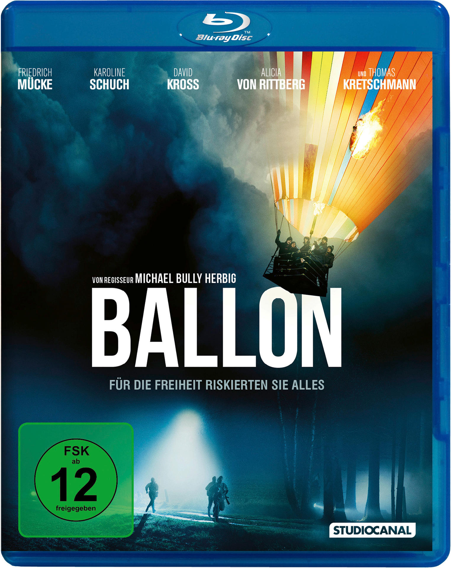 Ein Ballon mit Menschen steigt auf, Flammen lodern. Titel: BALLON.