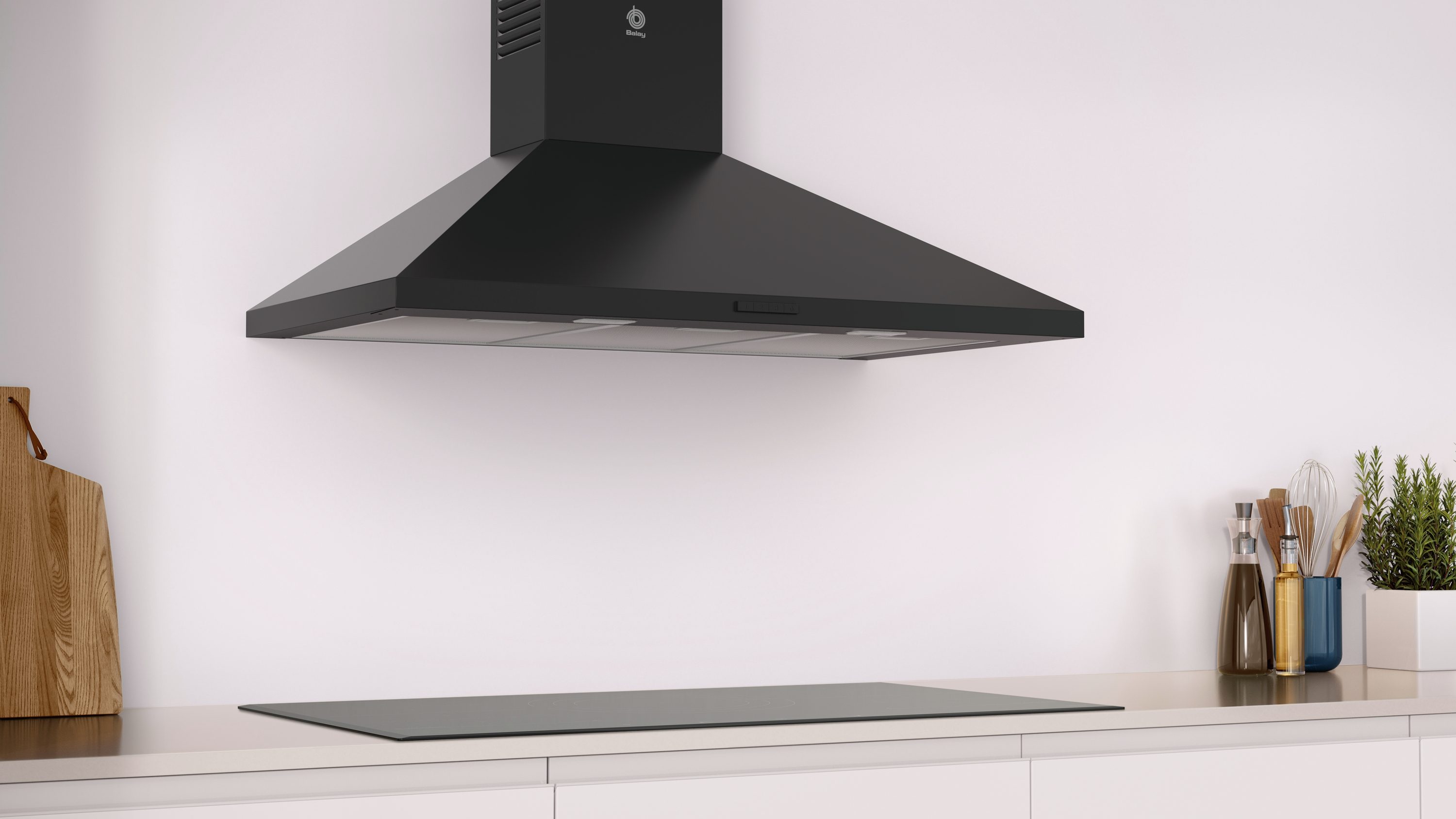 Campana extractora negra sobre vitrocerámica negra en cocina blanca.