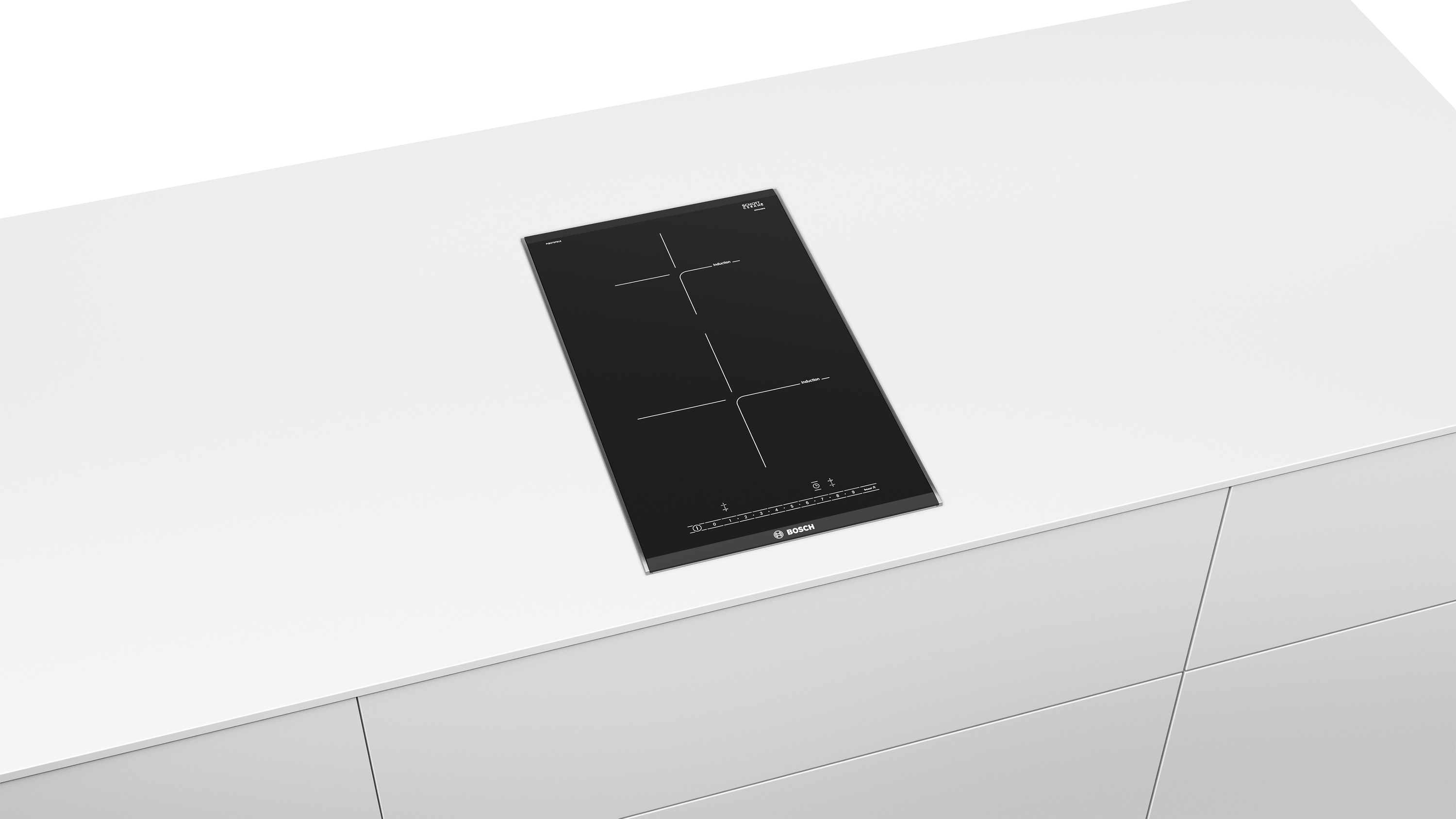 Una placa de inducción negra sobre una encimera blanca.