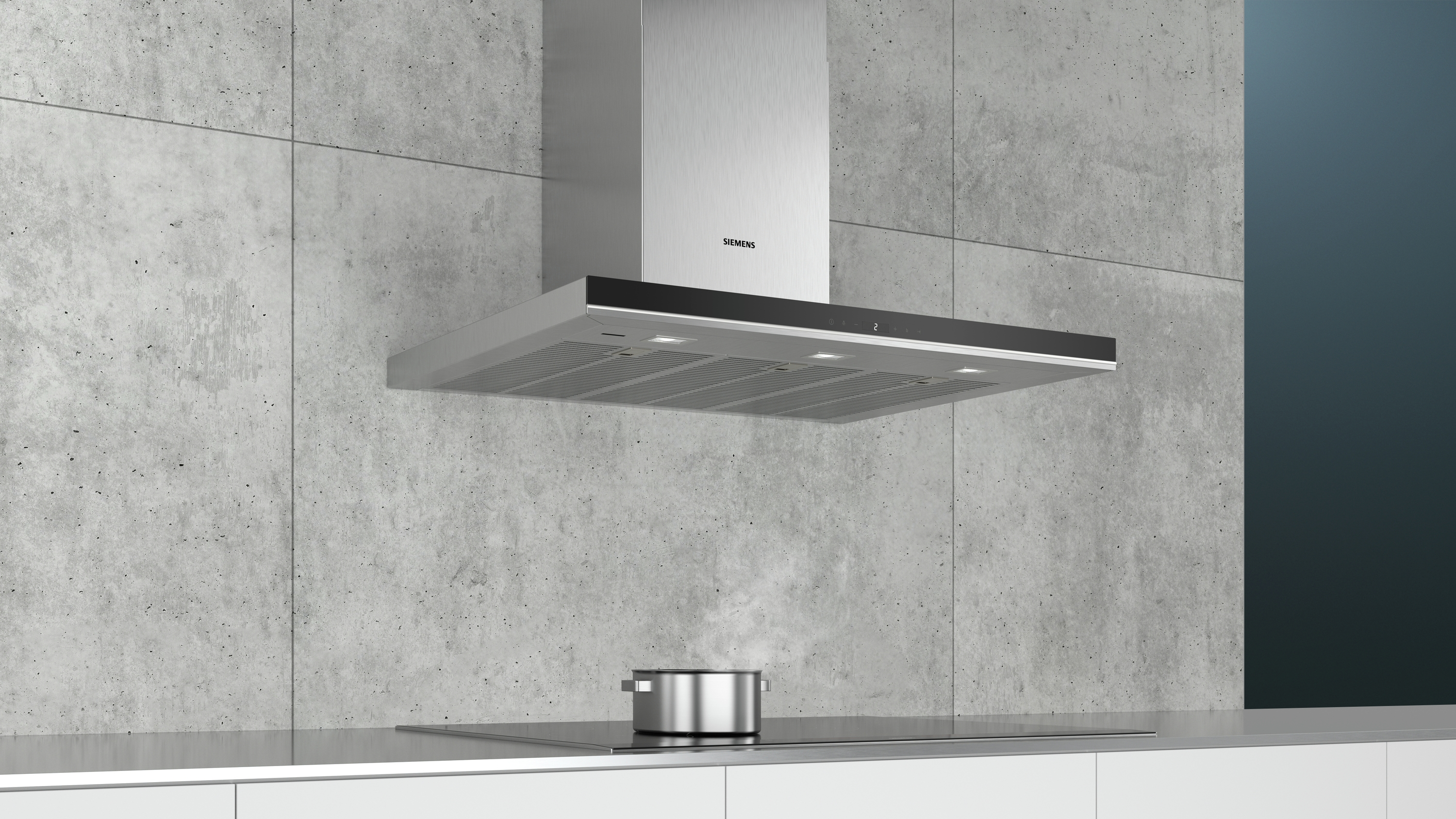 Cocina con campana de acero inoxidable y olla en la estufa.